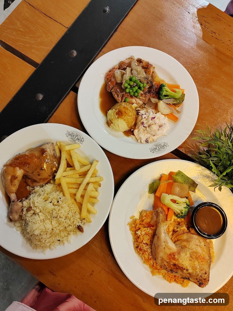 Three plates of food on a wooden table
