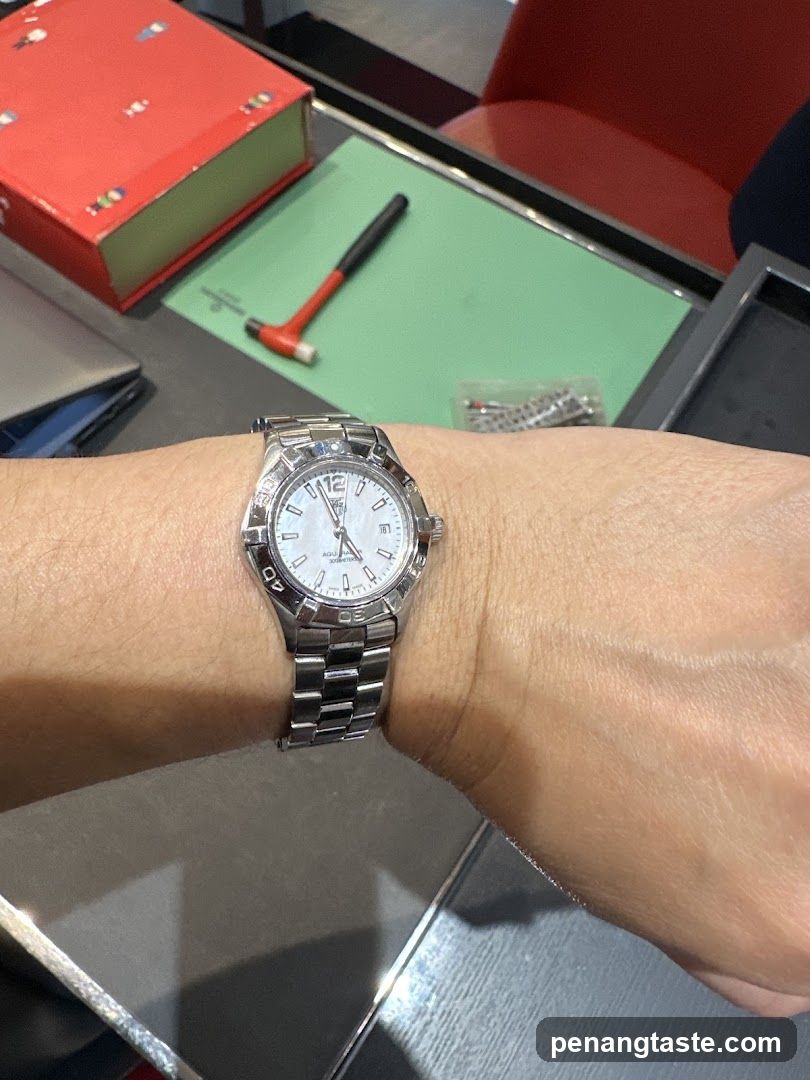 Watch on wrist with tools nearby