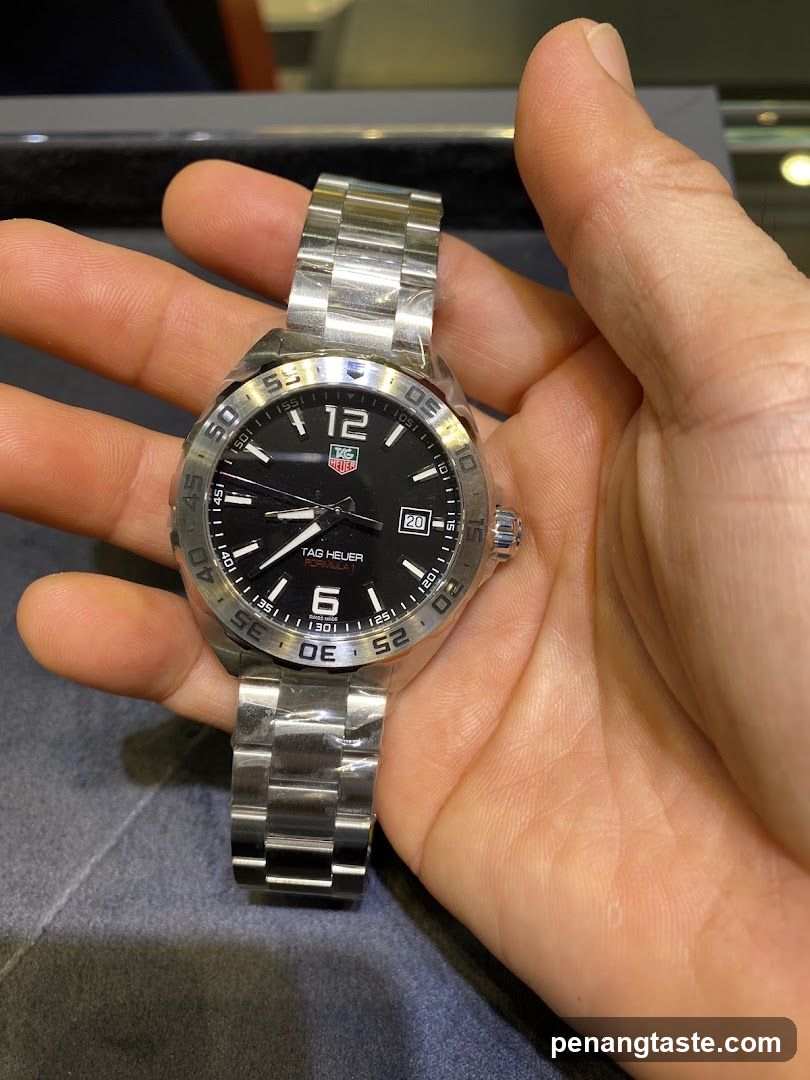 Tag Heuer watch held in hand