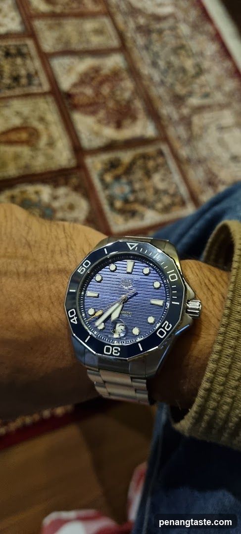 Watch on wrist with patterned rug background