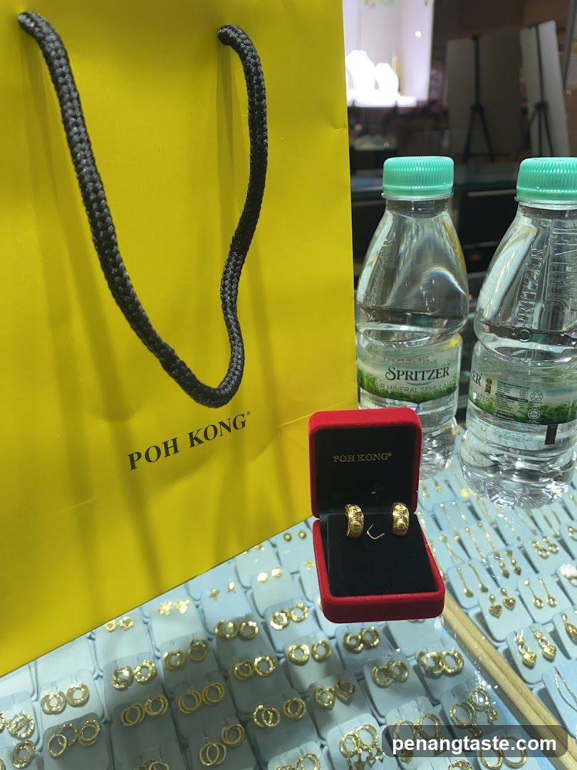 Gold Jewelry Display with Shopping Bag and Water Bottles