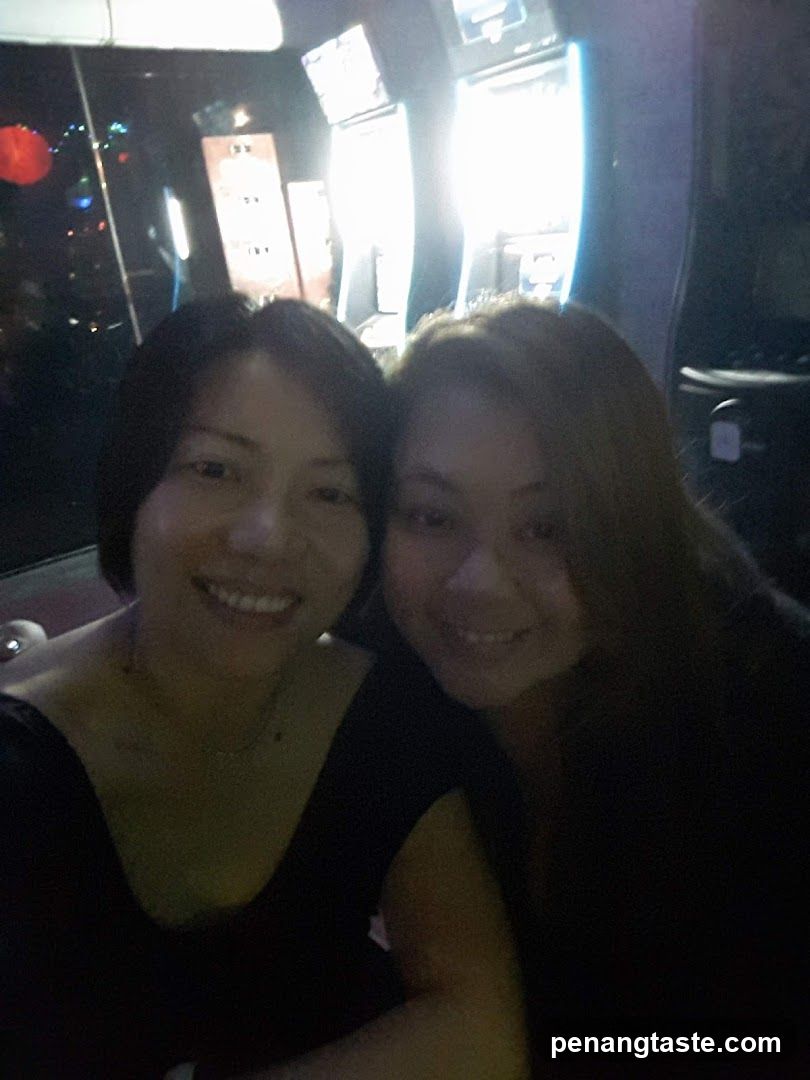 Two women smiling indoors at night