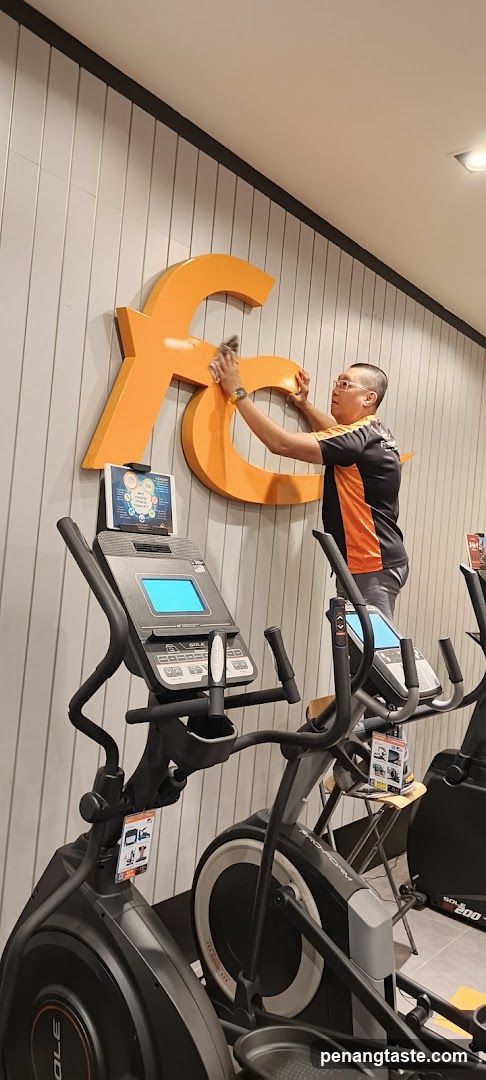 Gym Interior with Staff Cleaning Signage