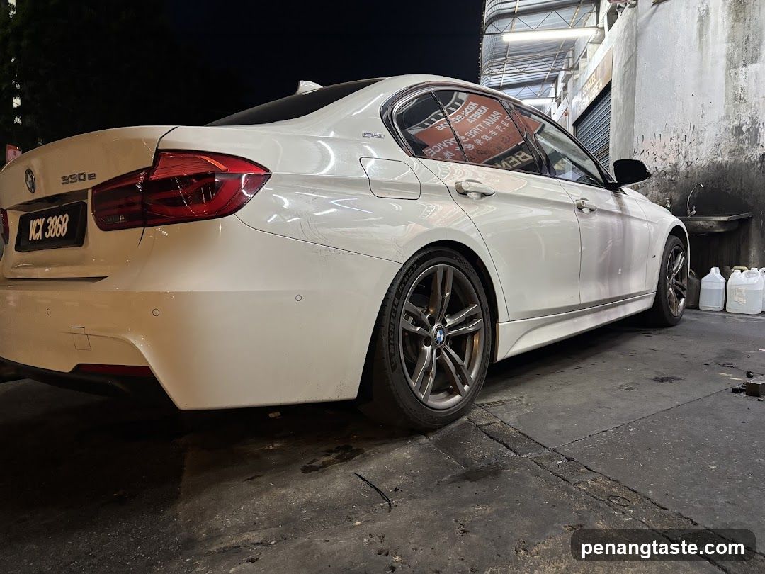White BMW 330e at night