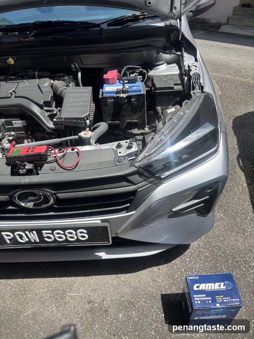 Car Engine Bay with Battery and Multimeter