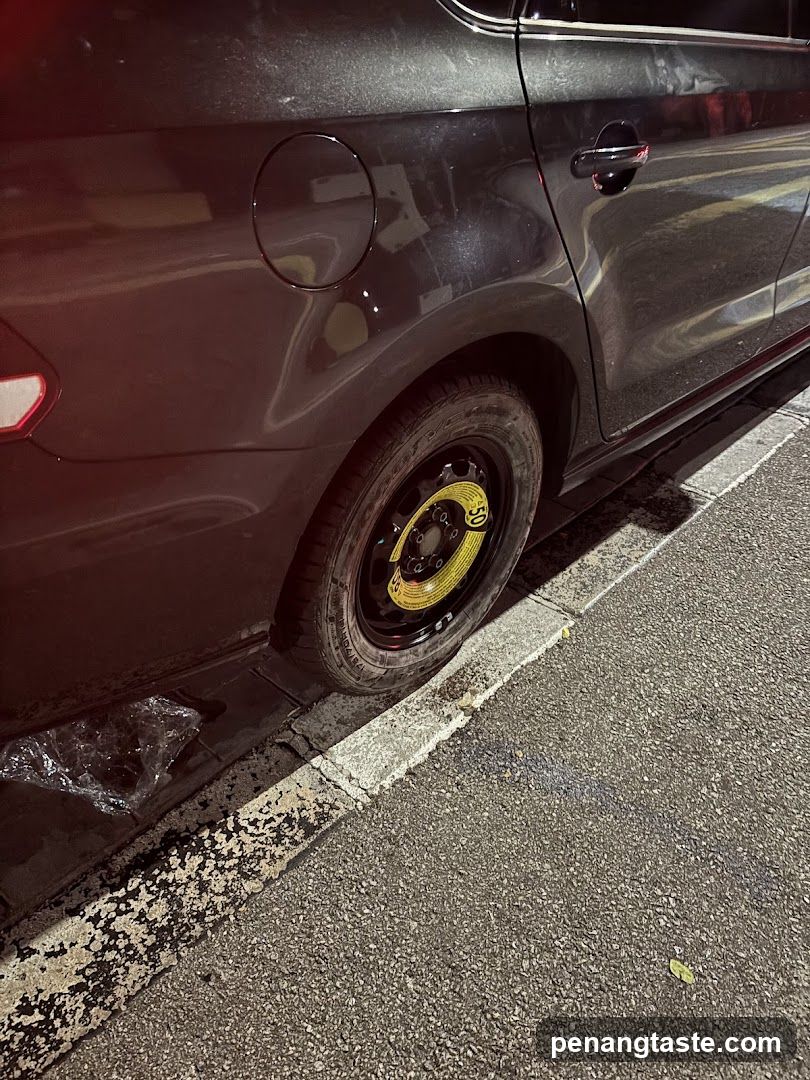 Car with spare tire on street