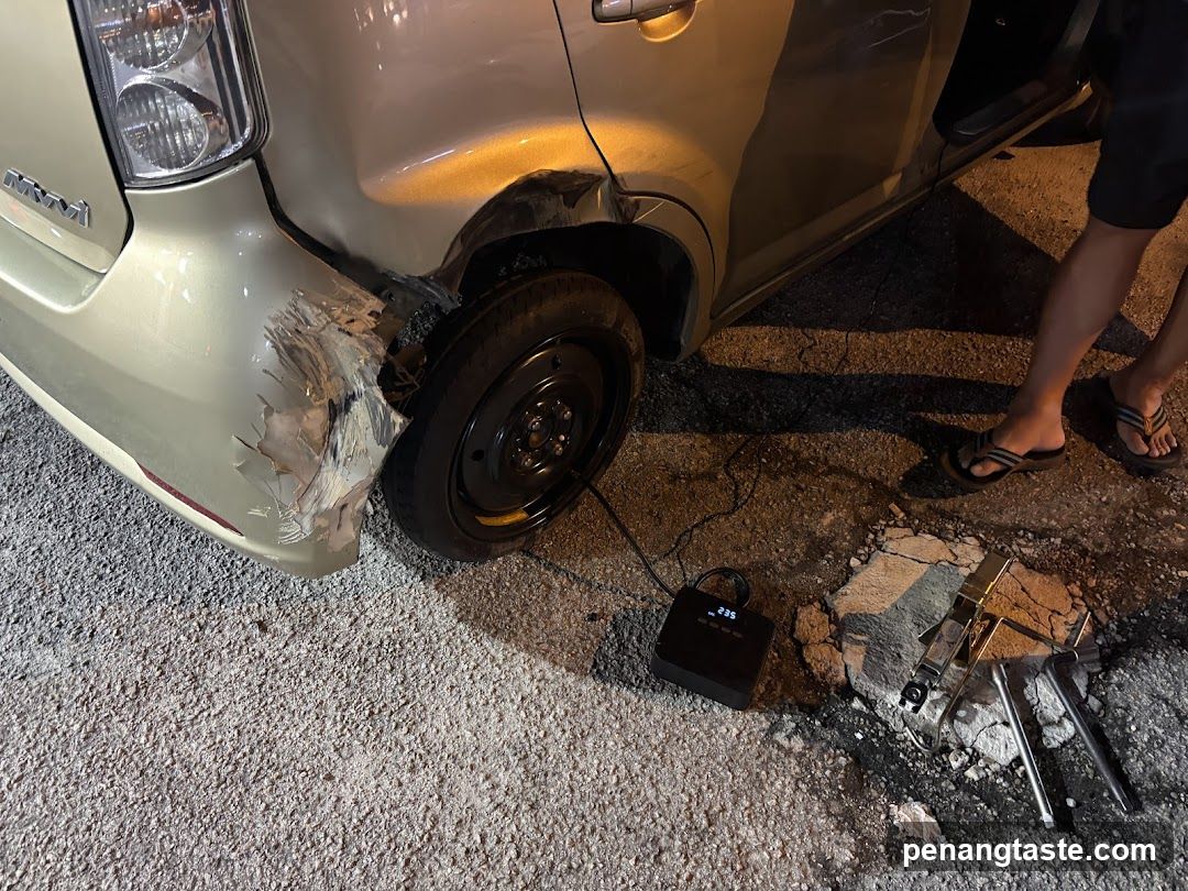 Damaged Car with Broken Wheel and Tools Nearby