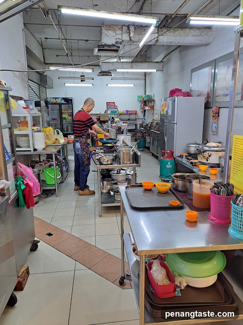 Kitchen Interior with Chef Cooking