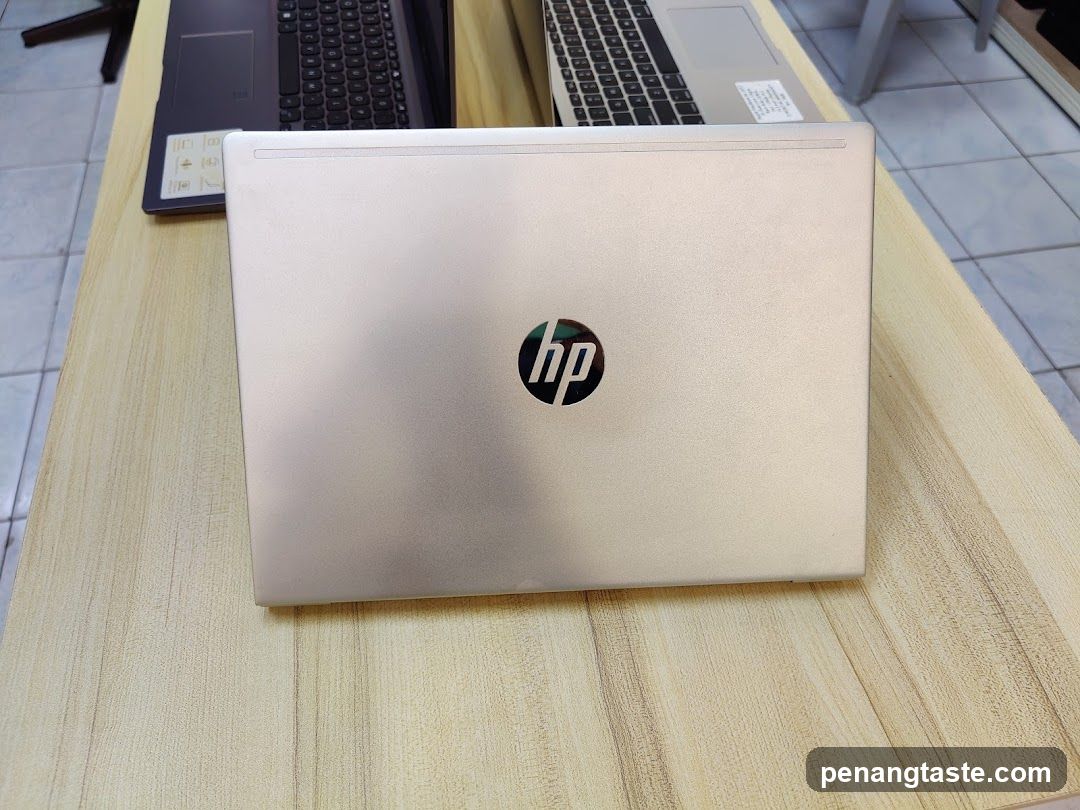 HP Laptop on Wooden Table
