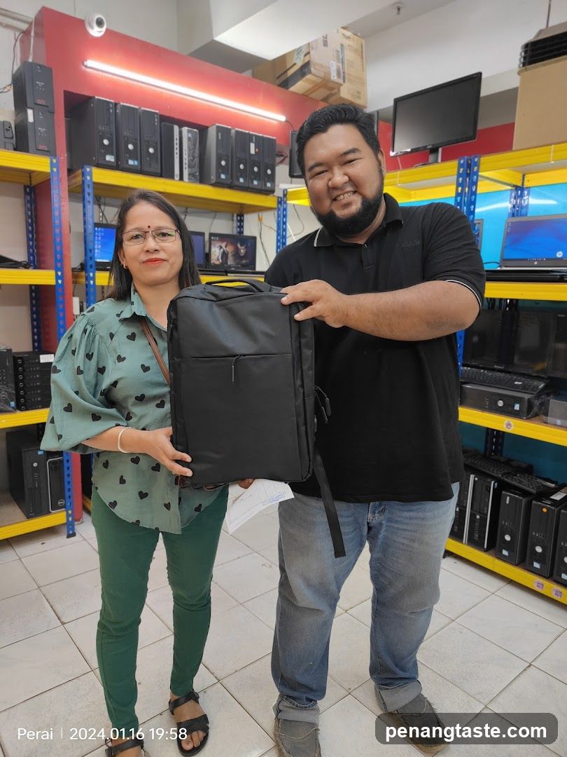 Tech Store Interior with Staff Holding Laptop Bag