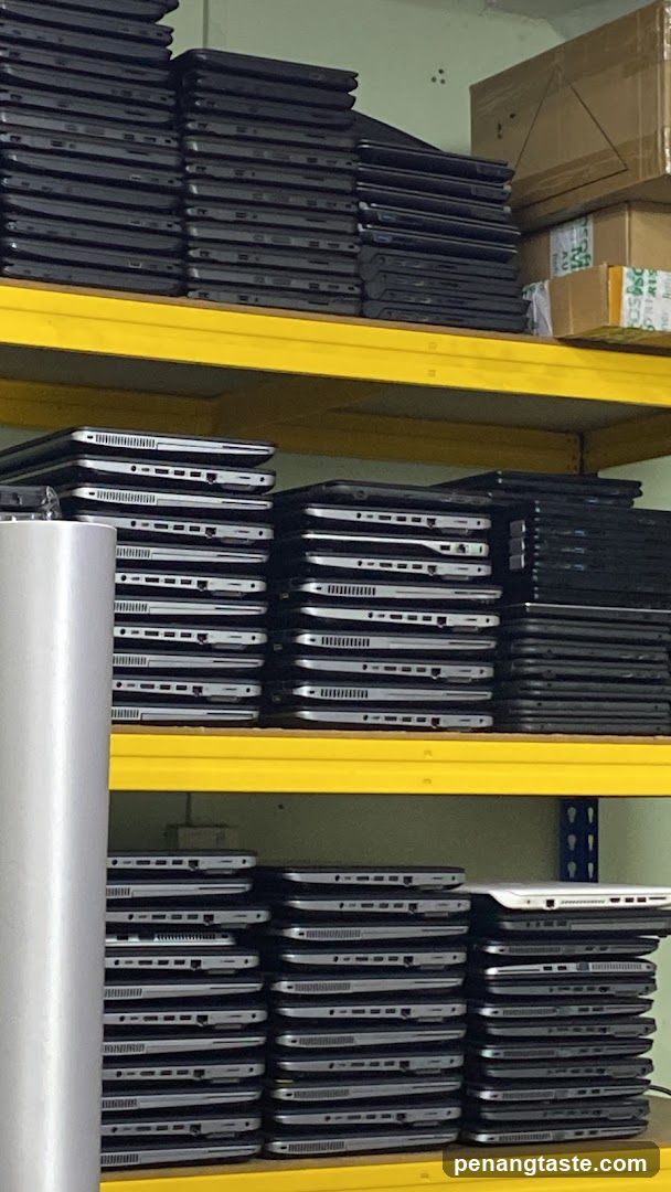 Stacked Laptops on Yellow Shelves