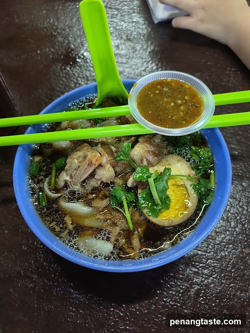 Bowl of Soup with Halved Egg and Meat