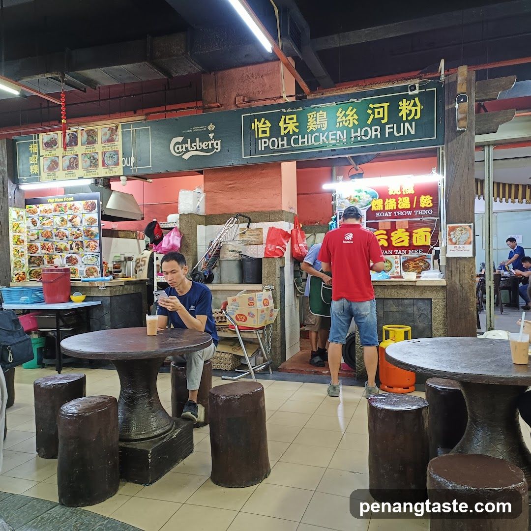 Food stall interior with customers and staff