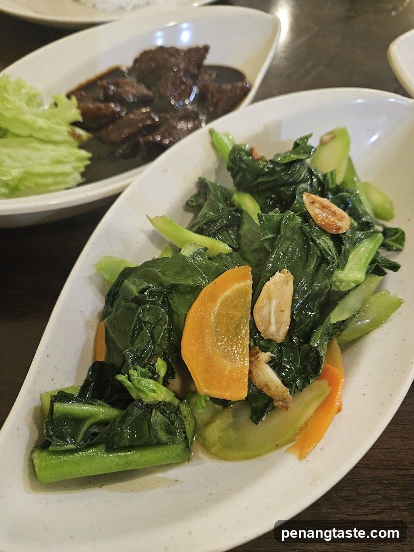 Dish with stir-fried greens and orange slices