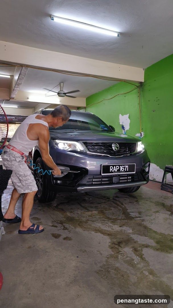 Man Washing Car in Garage