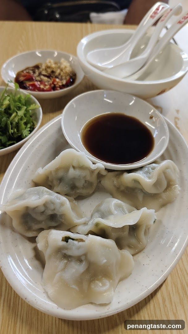 Dumplings with dipping sauces and garnish
