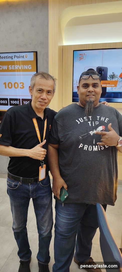 Two men posing in a store