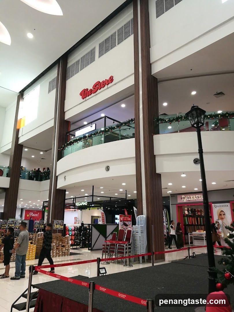 Shopping Mall Interior with Storefronts and Staged Area