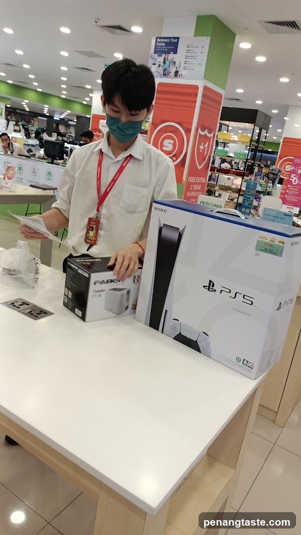 Electronics Store Interior with Staff Handling Products