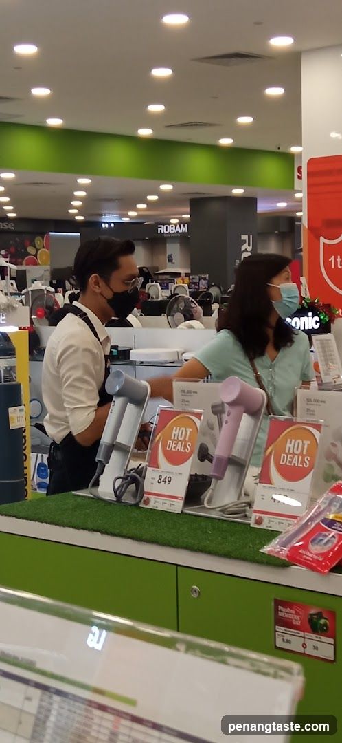 Electronics Store Interior with Staff and Customer