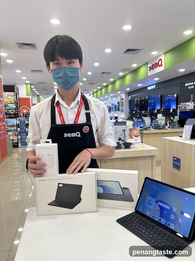 Electronics Store Interior with Staff Displaying Tablets