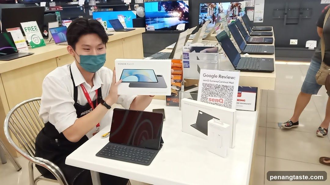 Electronics Store Interior with Staff Displaying Product