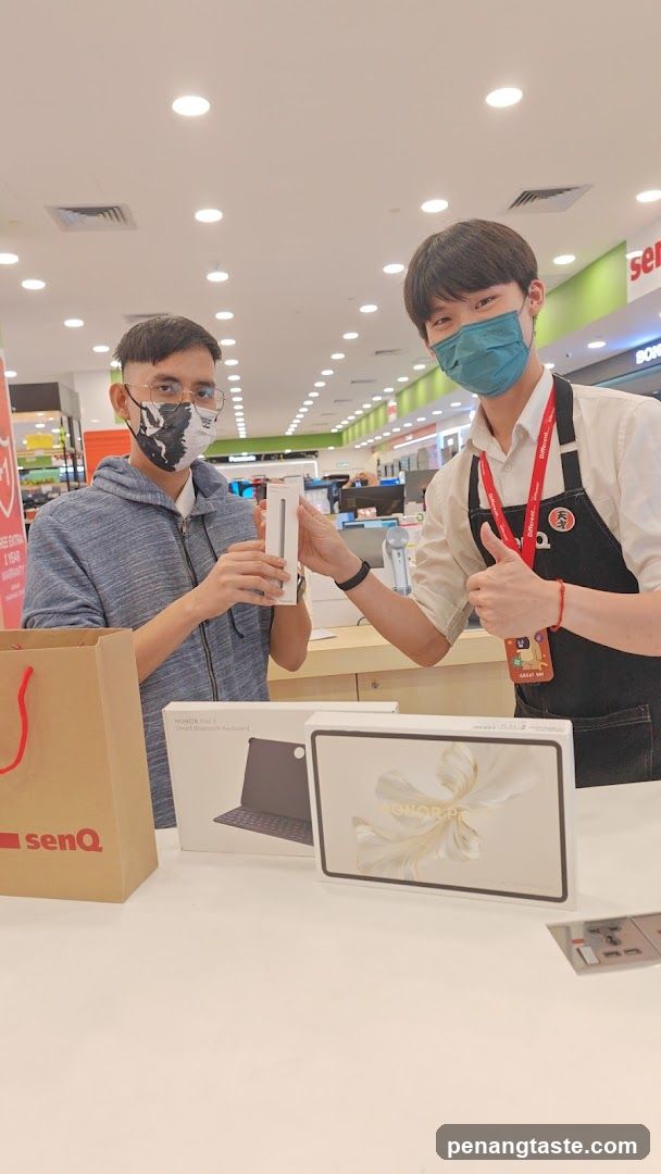 Customer and Staff with Electronics in Store