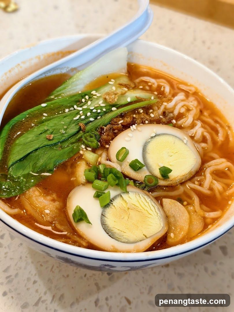 Bowl of Ramen with Halved Eggs and Greens