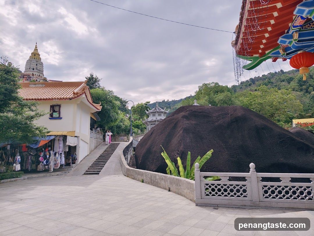 Temple Courtyard with Shop and Rock Formation