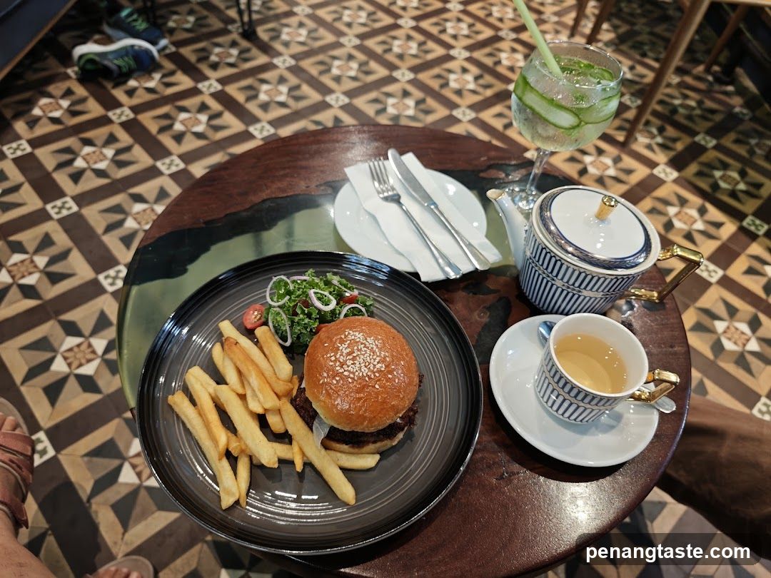 Burger and Tea Set on Patterned Floor