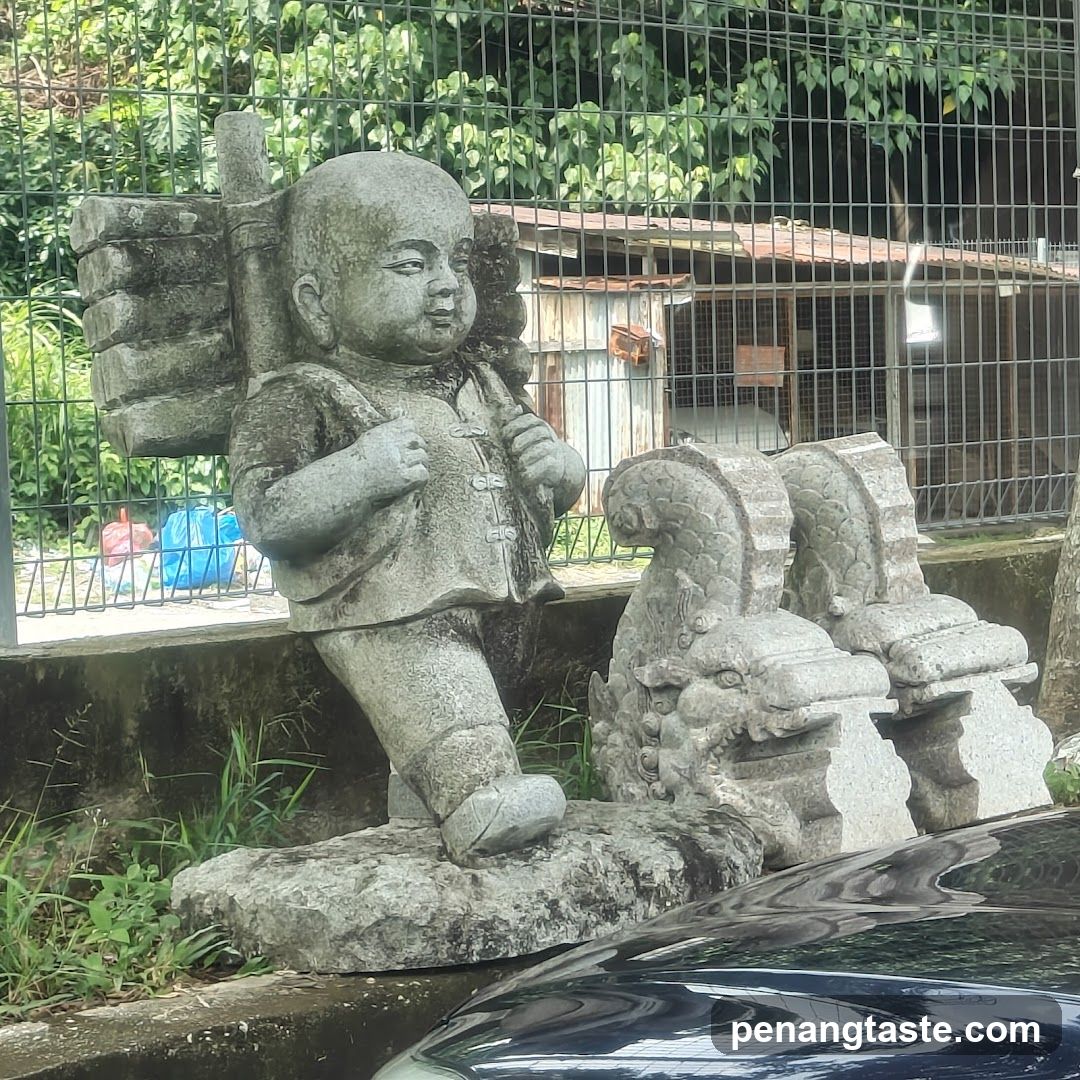Stone Statue of Child Carrying Backpack