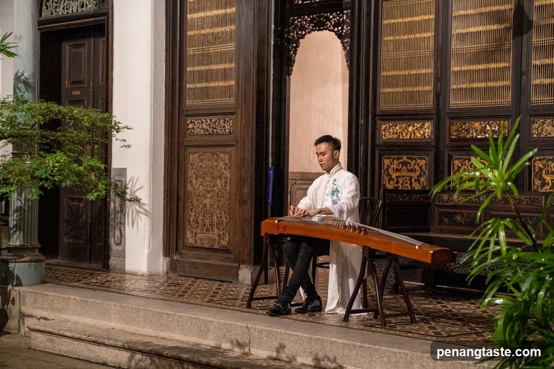 Guzheng Player at Traditional Entrance