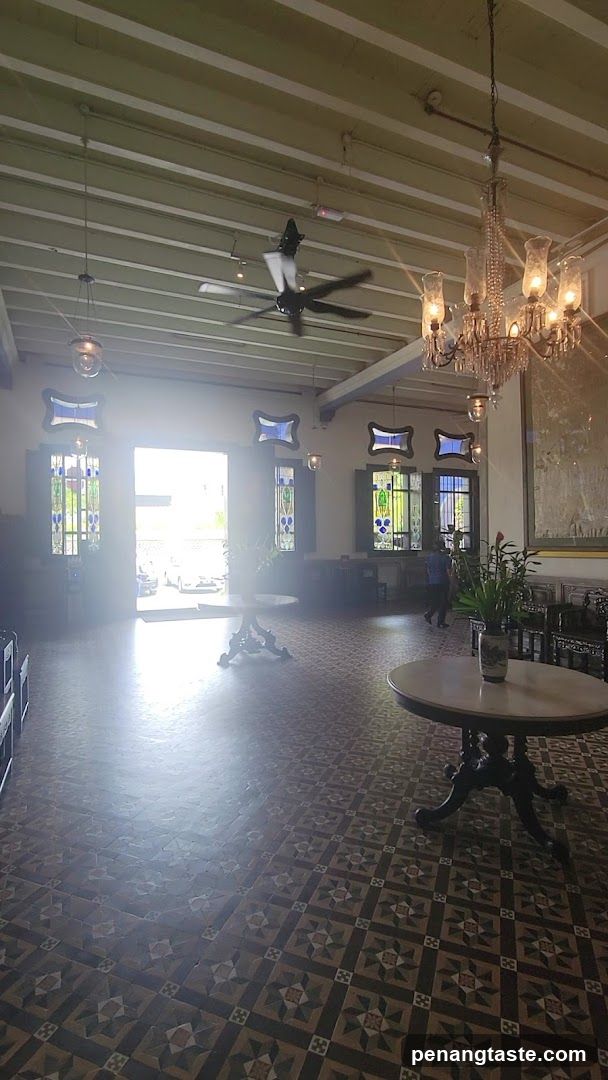 Interior of a historic building with tiled floor and chandeliers