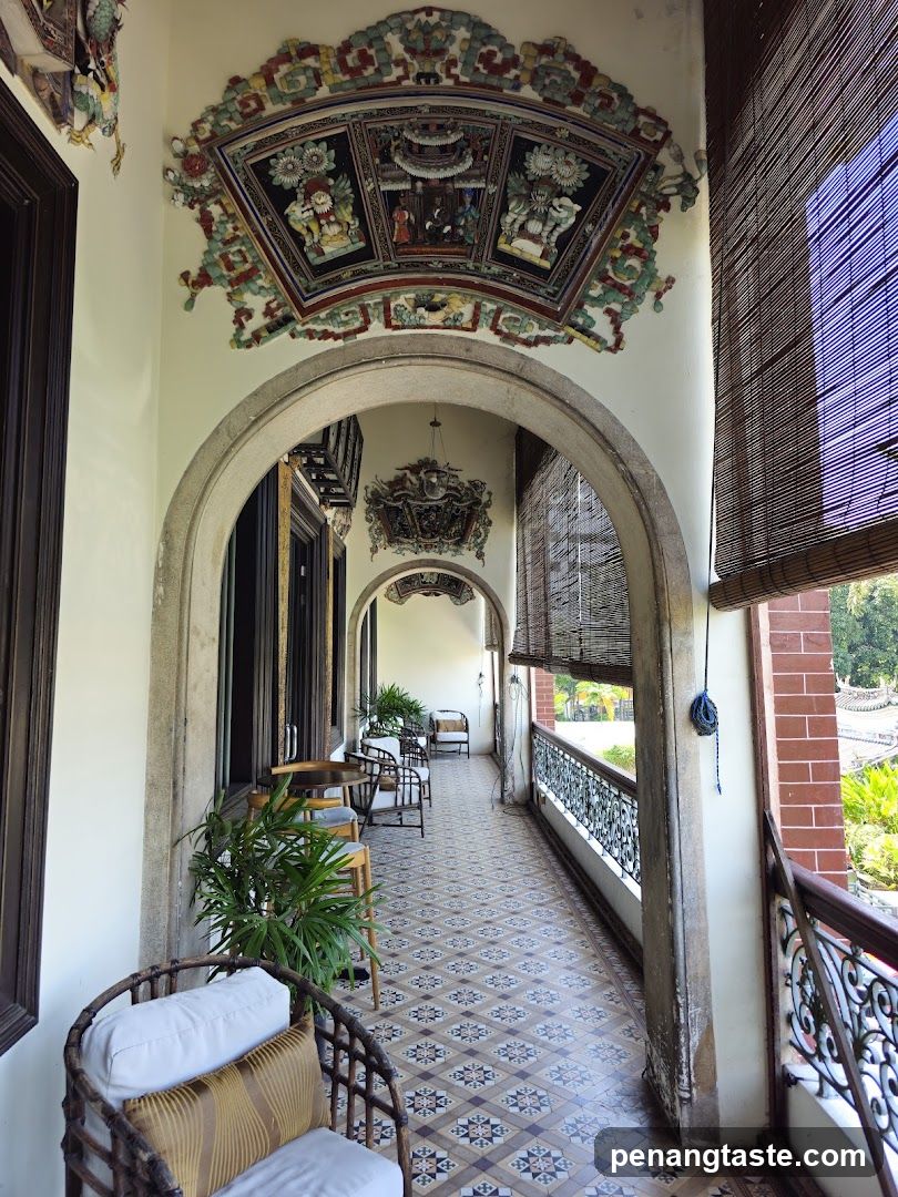 Traditional Corridor with Intricate Ceiling Artwork