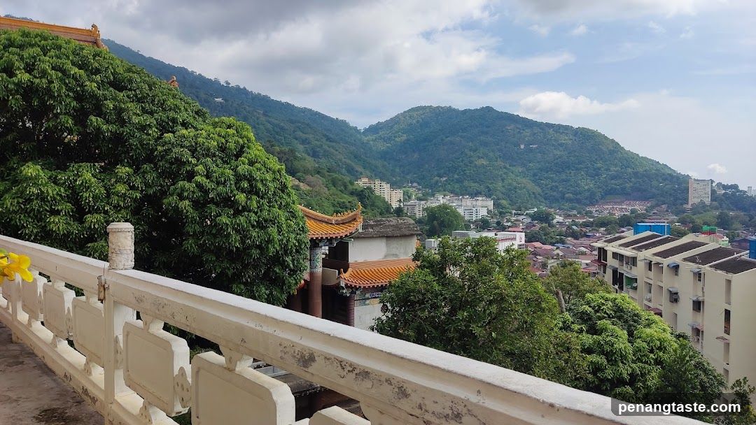 View from a temple balcony overlooking a city and mountains