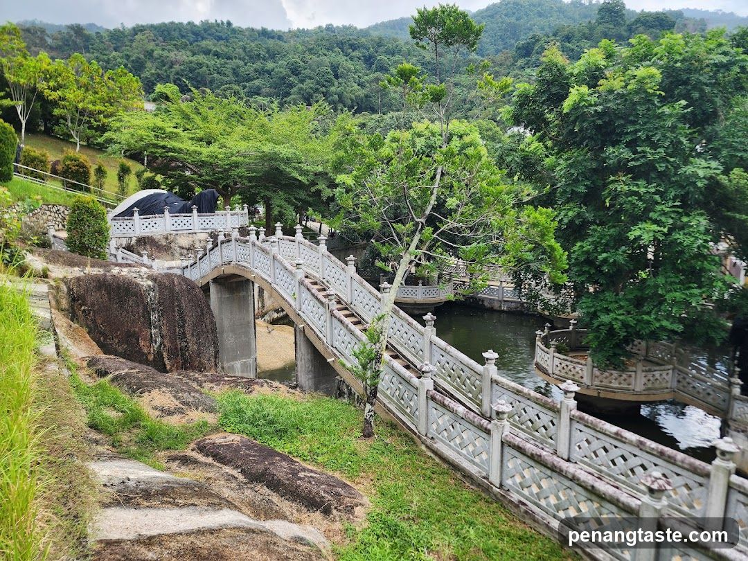 Landscape with stone bridge and lush greenery