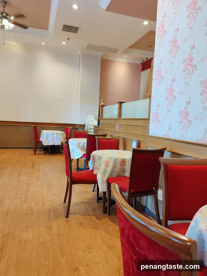Restaurant Interior with Floral Wallpaper and Red Chairs