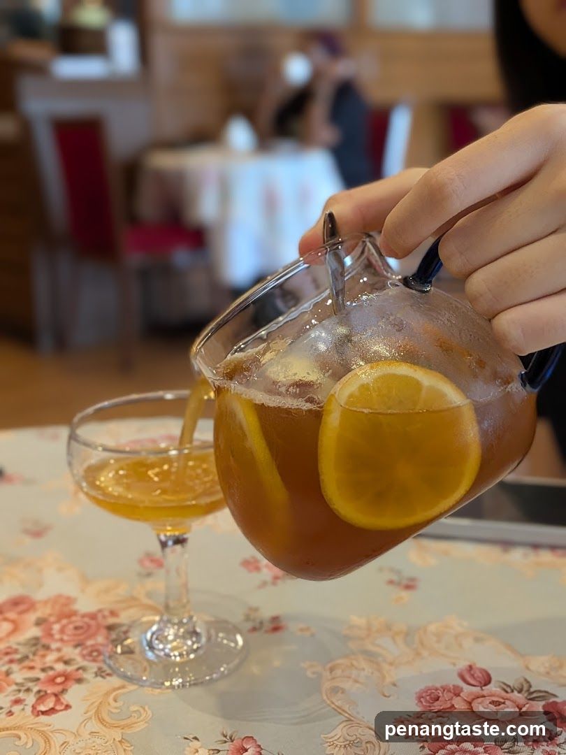 Pouring Lemonade with Ice and Citrus Slices