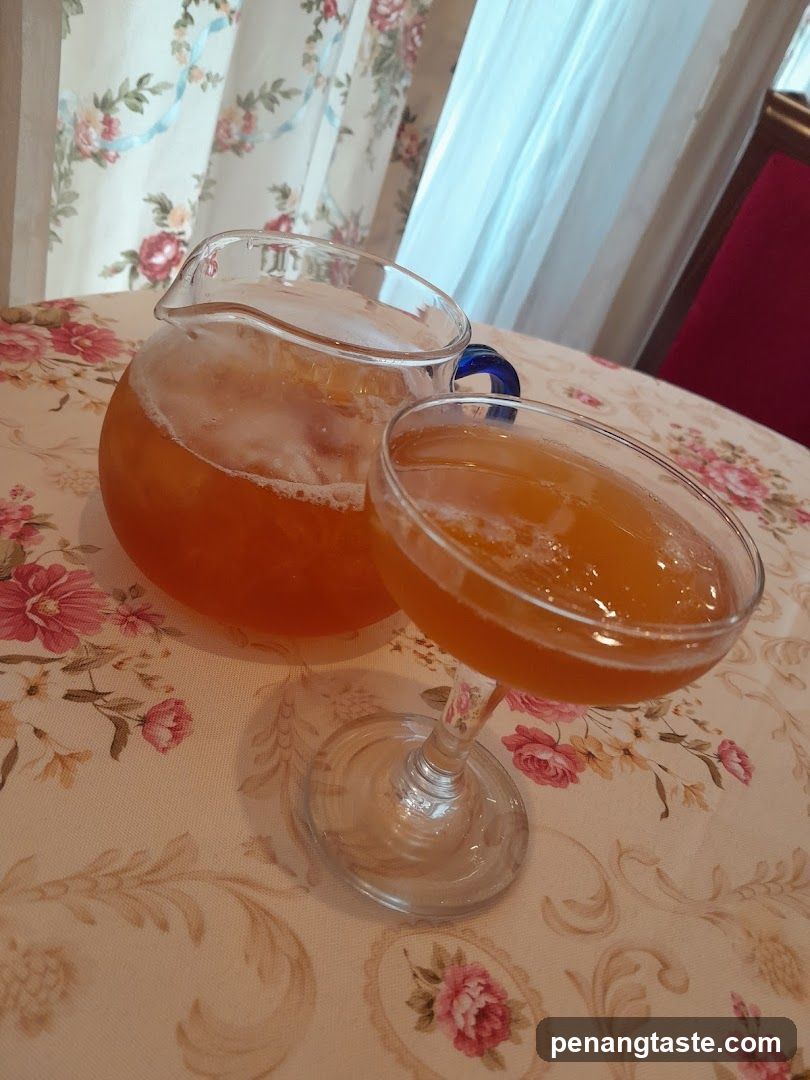 Iced Tea and Pitcher on Floral Tablecloth