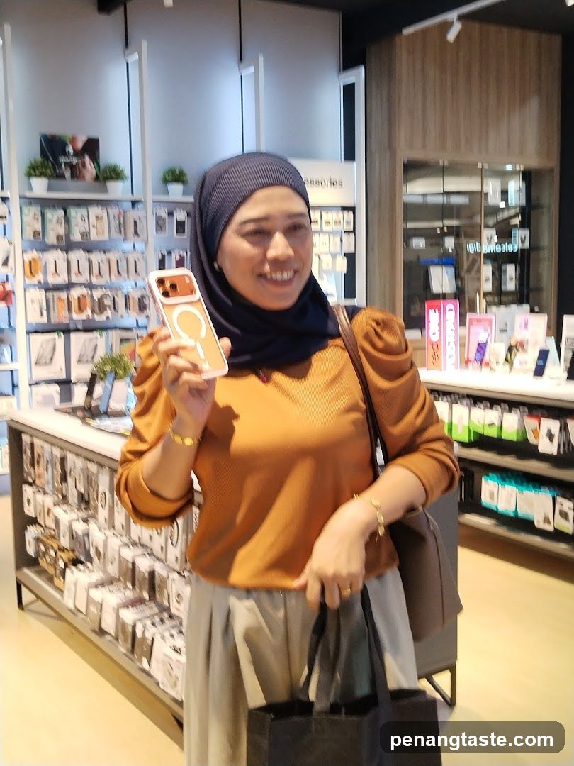 Woman holding phone case in electronics store