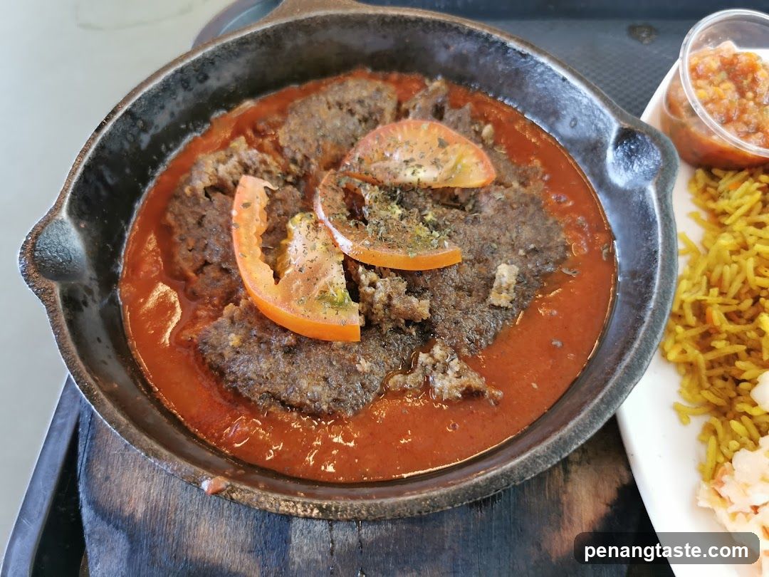 Sizzling Meat Dish with Tomato Slices and Rice