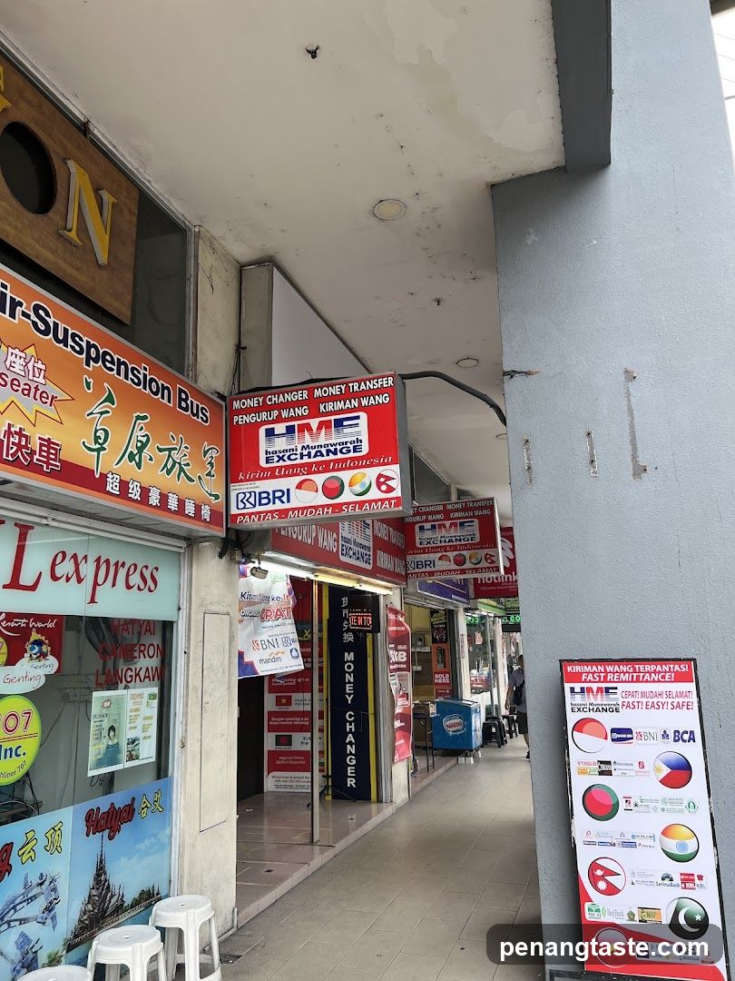 Street-side storefronts with currency exchange and transport signs