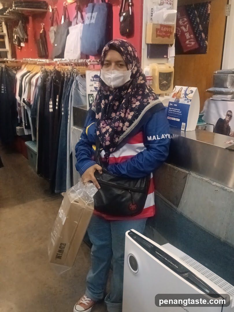 Woman in Store Holding Shopping Bag