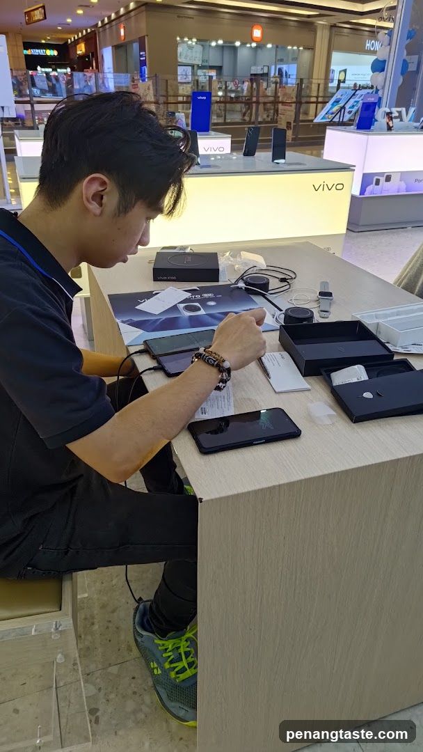 Person assembling electronics in mall