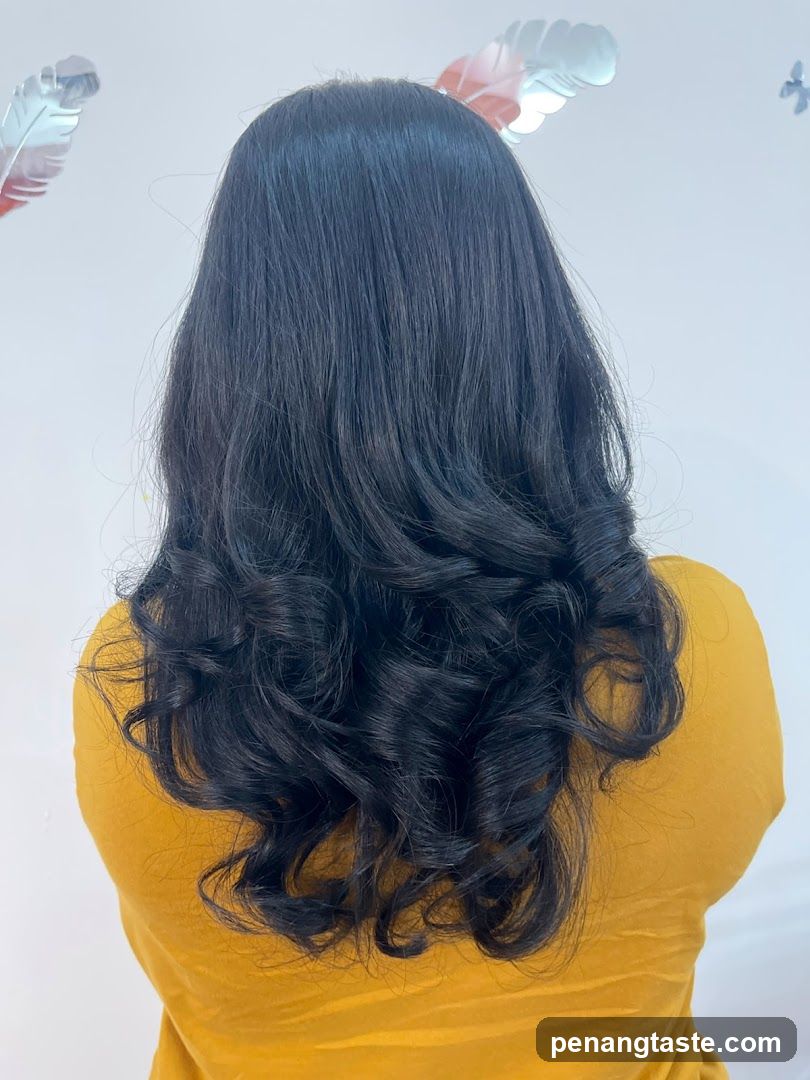 Woman with long wavy black hair from behind