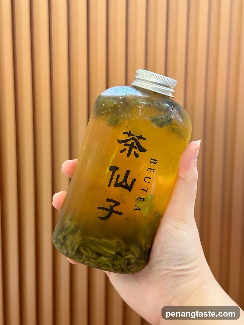 Hand holding a bottle of tea