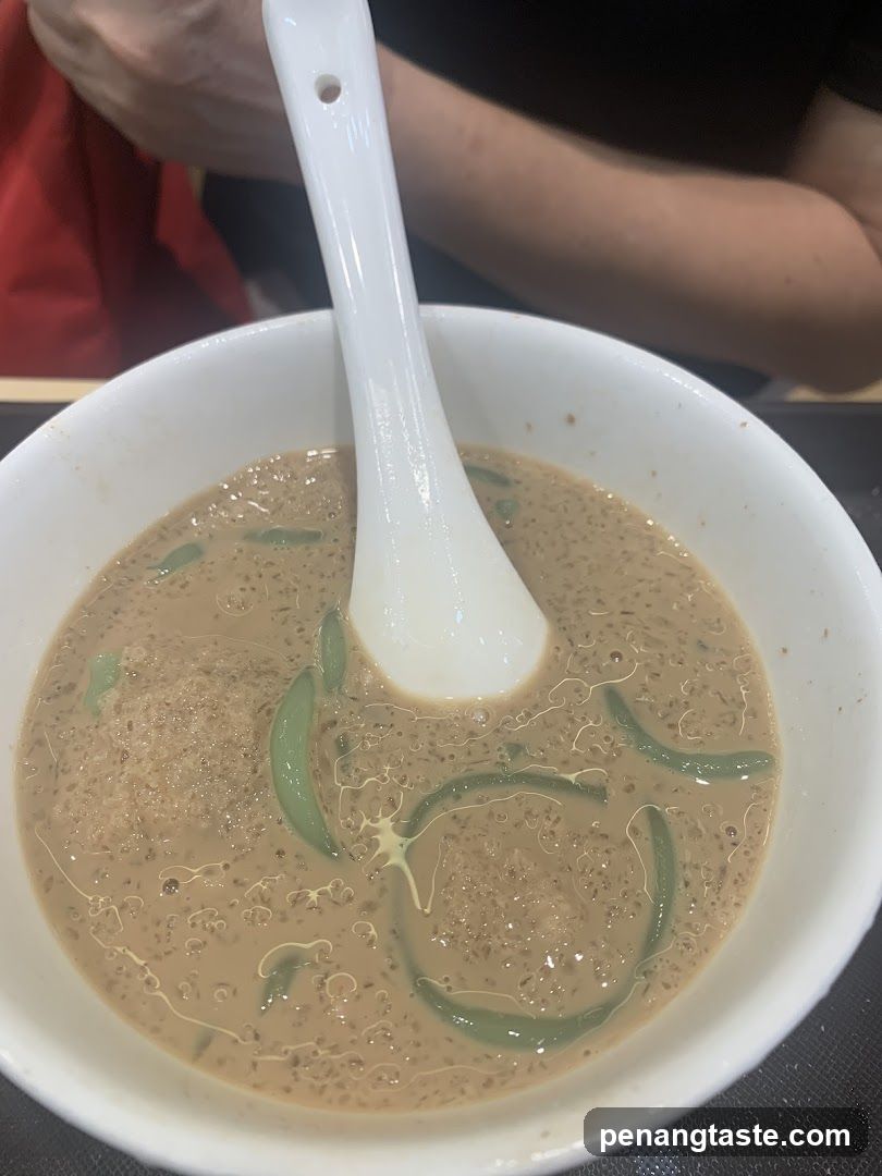 Bowl of soup with green garnish