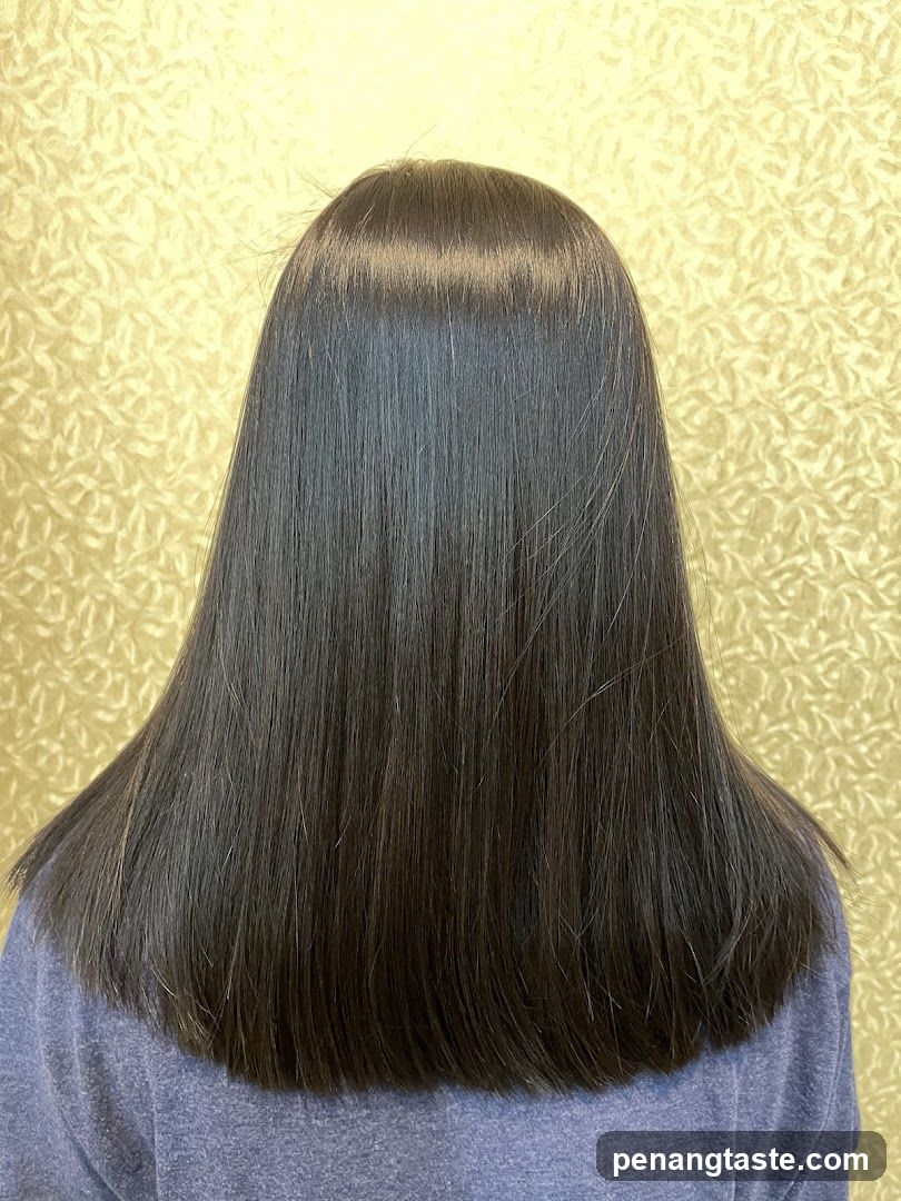 Back of a person with long straight hair