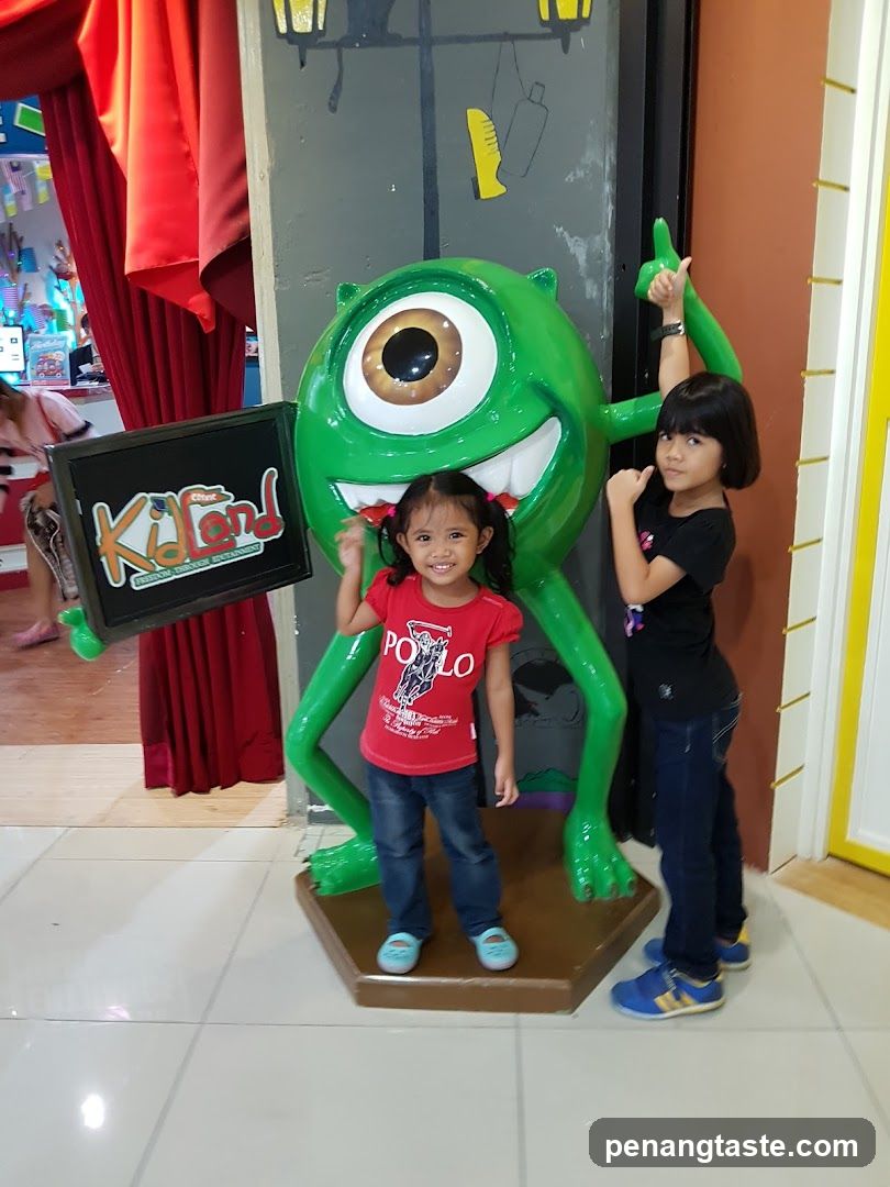 Kids with Mike Wazowski Statue