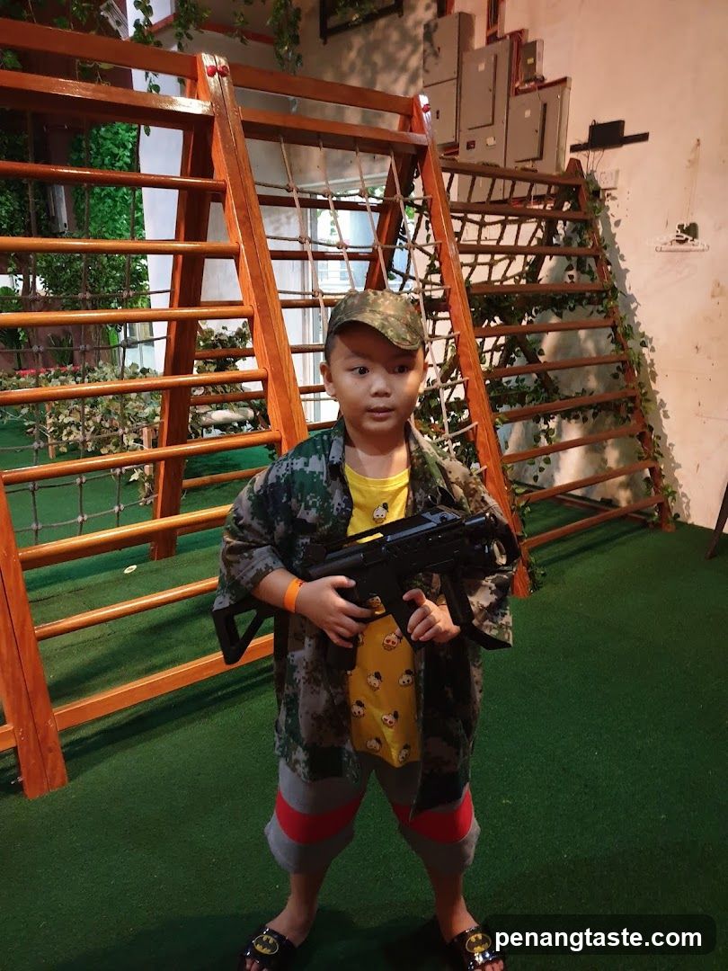 Child in Camouflage Outfit with Toy Gun